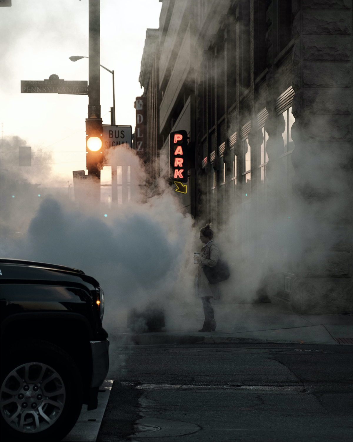 Person standing on hazy street corner